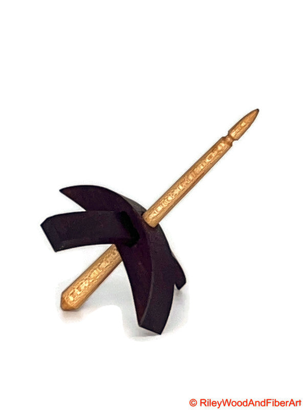 A Mini Turkish drop spindle that has a purple heart whorl and a maple shaft  made by riley wood and fiber art.