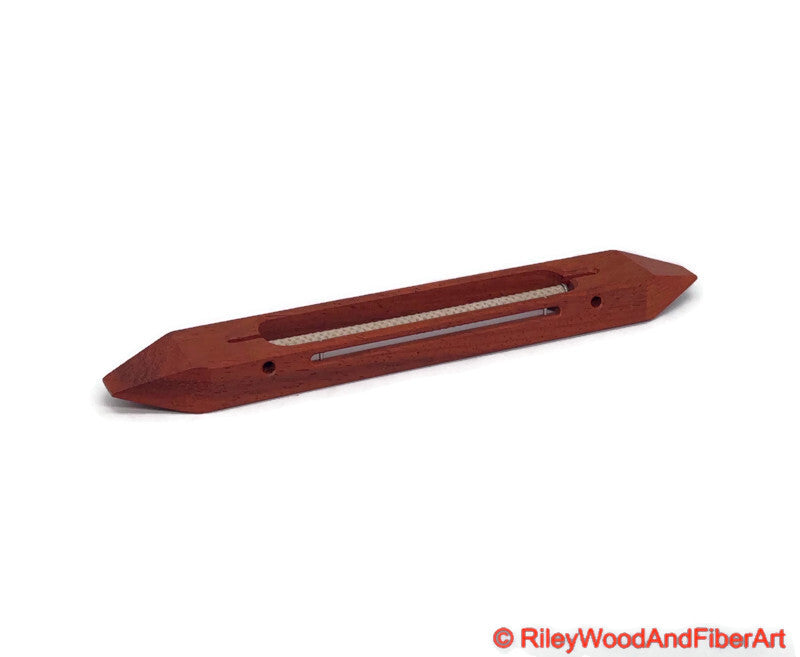 10 inch Padauk open bottom boat shuttle with a white background