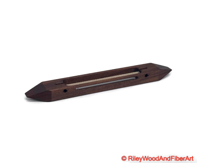 10 inch Walnut open bottom boat shuttle with a white background