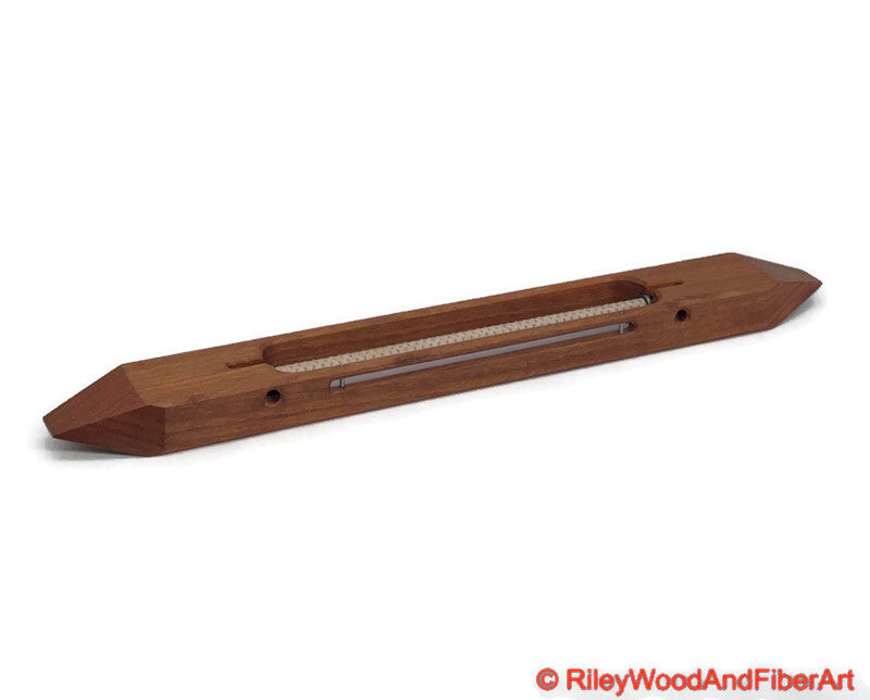 12 inch Cherry open bottom boat shuttle with a white background