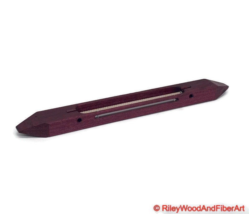 12 inch Purple Heart open bottom boat shuttle with a white background