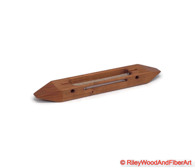 8 inch Cherry open bottom boat shuttle with a white background