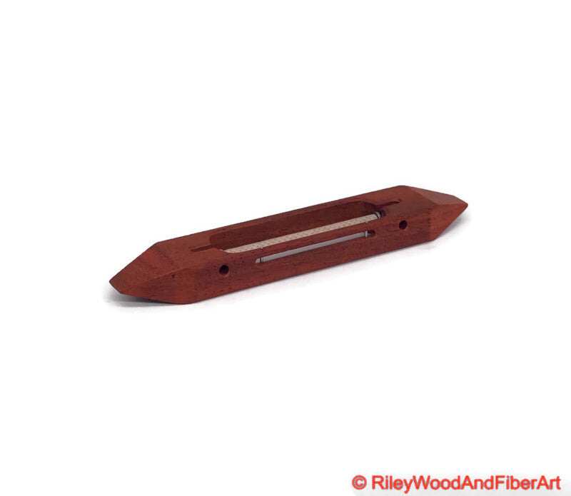 8 inch Padauk open bottom boat shuttle with a white background