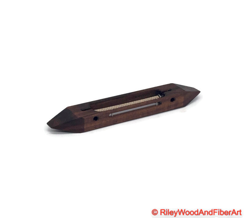 8 inch Walnut open bottom boat shuttle with a white background 