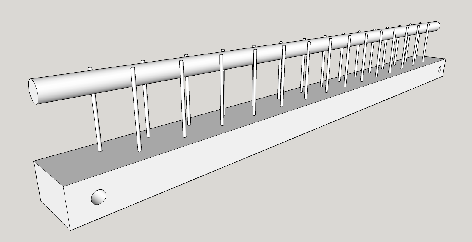 12 inch weaving raddle consists of a flat board with two rows of offset nails protruding vertically with a 3/8 inch dowel in between