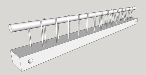 12 inch weaving raddle consists of a flat board with two rows of offset nails protruding vertically with a 3/8 inch dowel in between