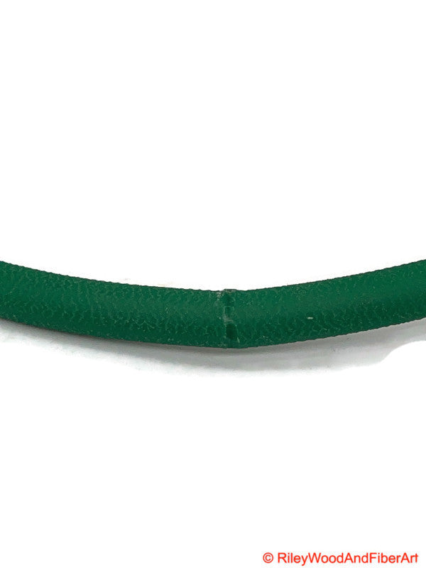 a length of green 1/4" polyurethane drive band material fused