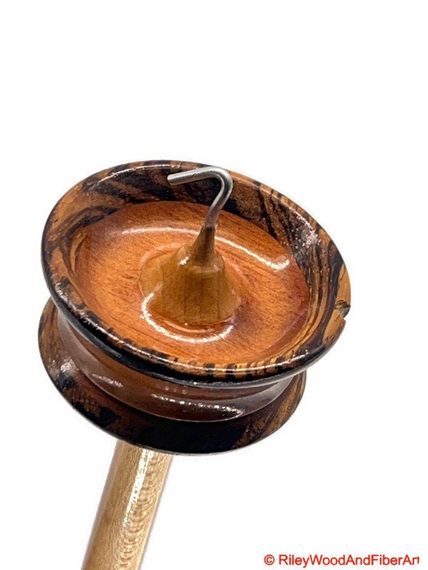 Top Whorl Drop Spindle - Zebra, Mahogany & Maple - 21g on white background