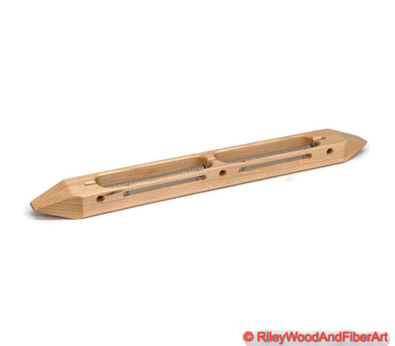 Maple open bottom double bobbin boat shuttle on a white background