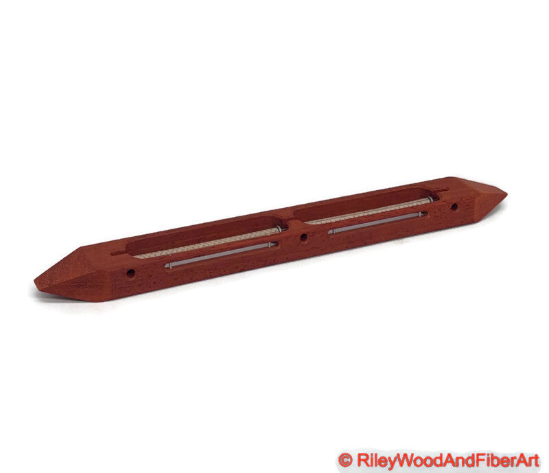Padauk open bottom double bobbin boat shuttle on a white background