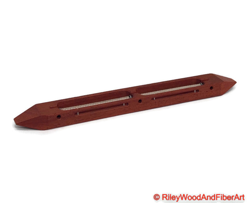 Padauk closed bottom double bobbin boat shuttle on a white background