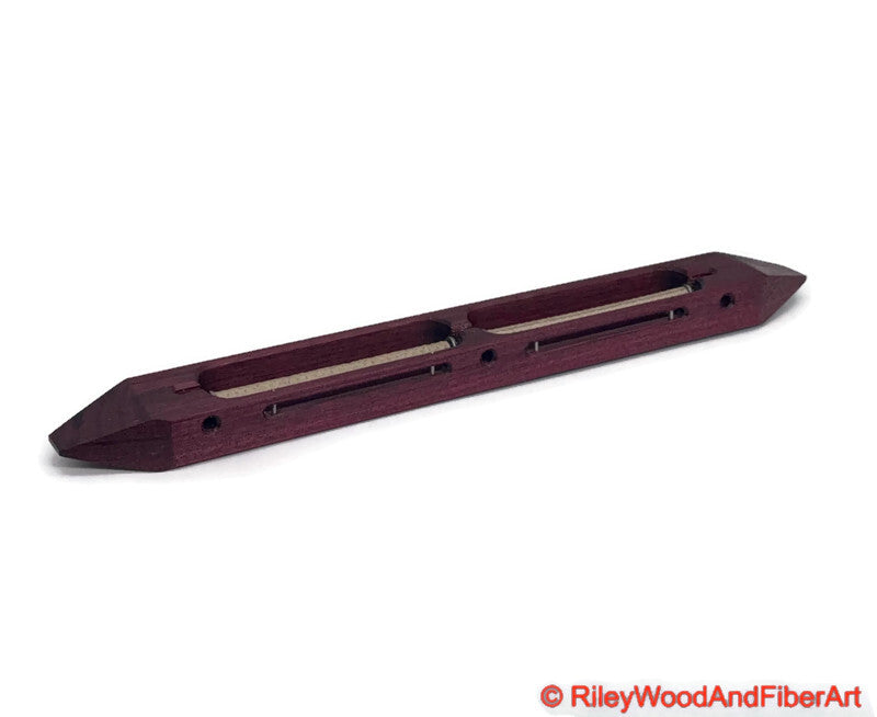 Purple Heart closed bottom double bobbin boat shuttle on a white background