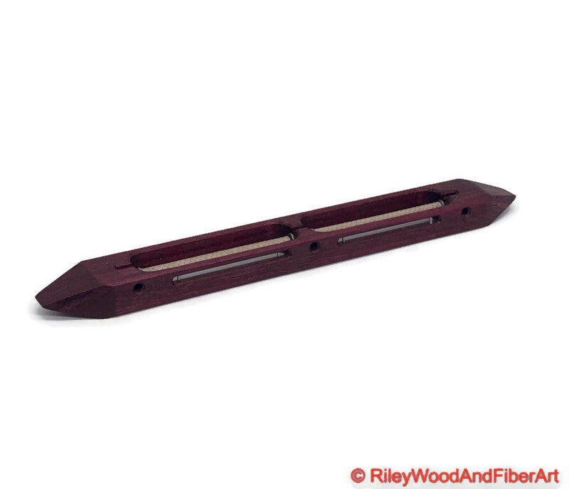 Purple Heart open bottom double bobbin boat shuttle on a white background
